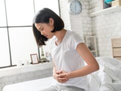 Woman holding stomach