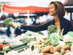 woman buying produce at a farmer's market