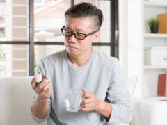 Middle-aged man reads a medicine bottle label. Methotrexate is a strong medicine that is used to treat some types of cancer, rheumatoid arthritis, psoriasis, and several other conditions.