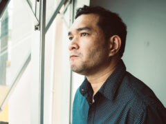 Closeup sad young man with worried stressed face expression looking out window and brain melting into lines question marks. Obsessive compulsive, adhd, anxiety disorders