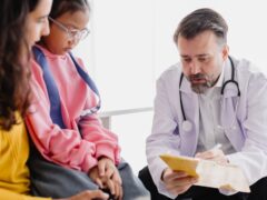A physician meeting with a family.